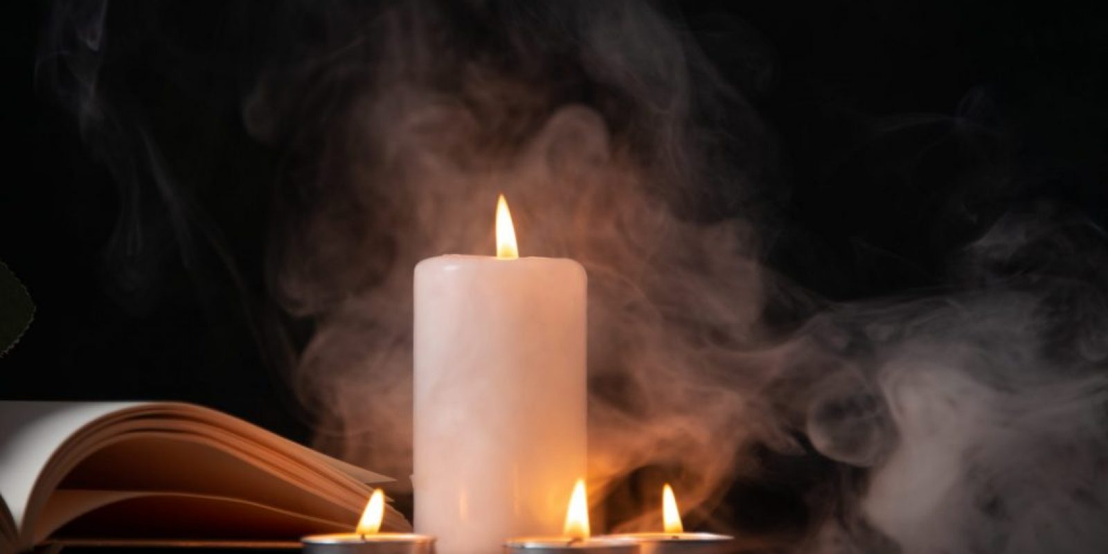 front-view-burning-candle-dark-surface