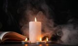 front-view-burning-candle-dark-surface