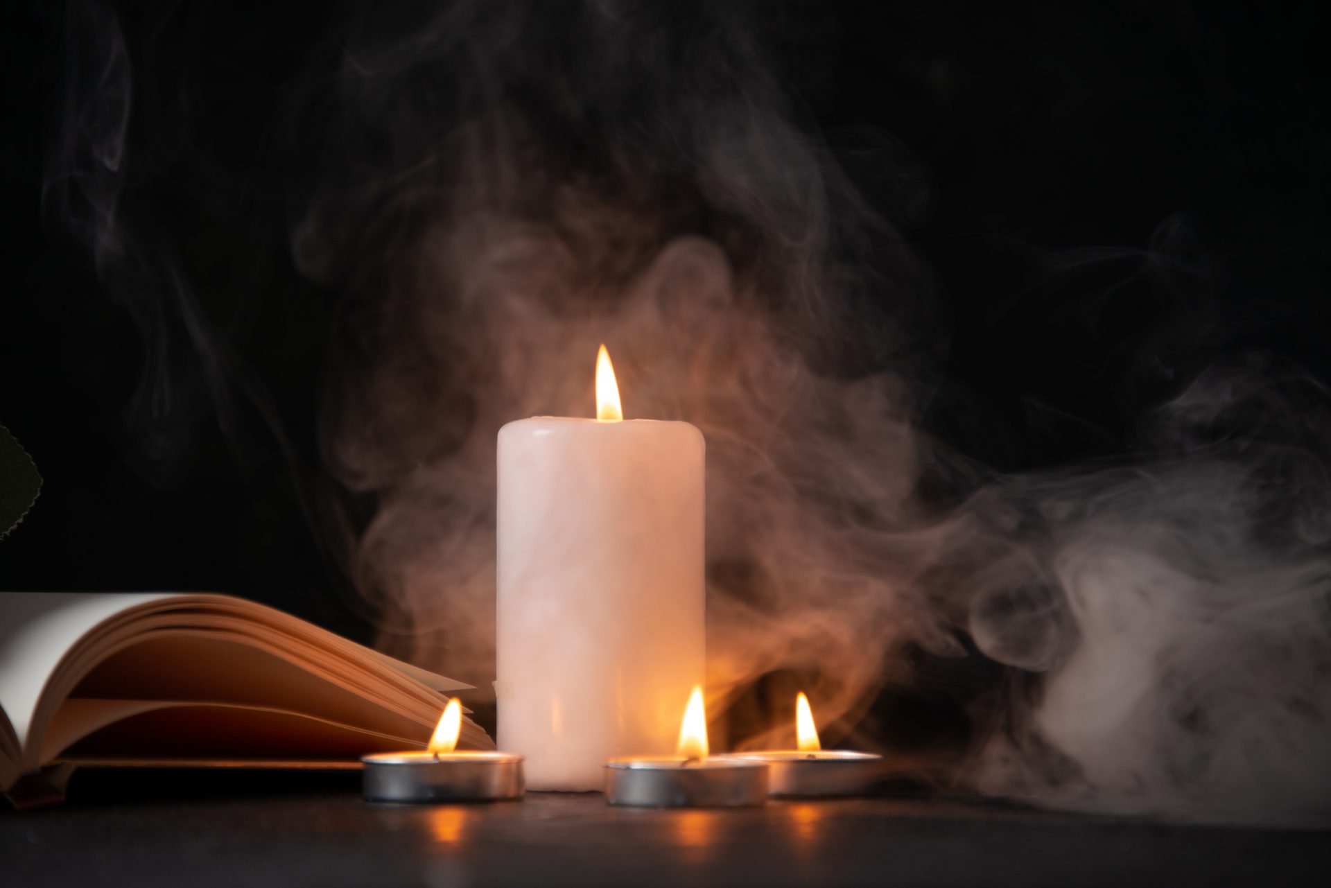 front-view-burning-candle-dark-surface